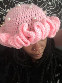 a woman wearing a pink crocheted hat